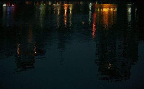 Reflection of trees in water at night