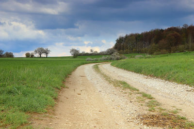 Dirt road along countryside landscape