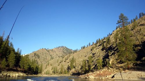 Scenic view of mountains against blue sky