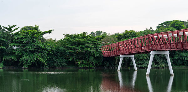 Gazebo by lake against sky