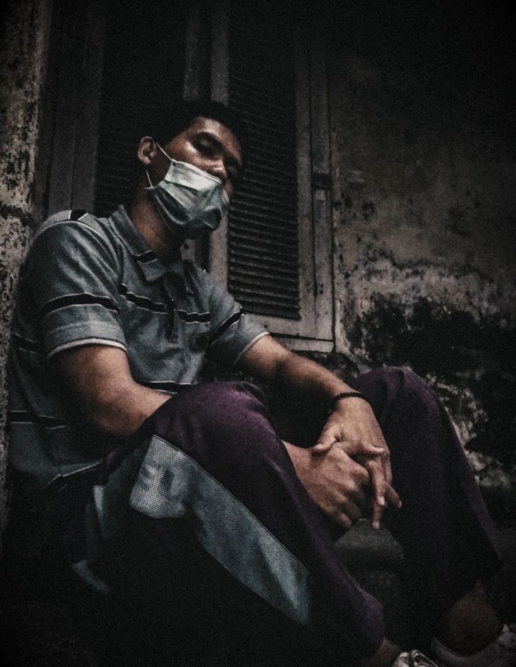 darkness, adult, social issues, men, one person, sitting, black, person, sign, dark, clothing, architecture, warning sign, indoors, human face, communication, healthcare and medicine