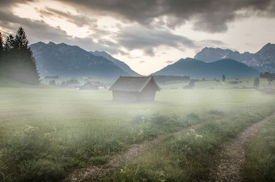 Scenic view of field and mountains against sky