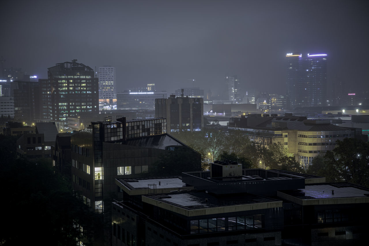 HIGH ANGLE VIEW OF ILLUMINATED BUILDINGS AGAINST SKY