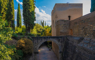 Beautiful arabian arches bridge between green gardens of the alhambra.