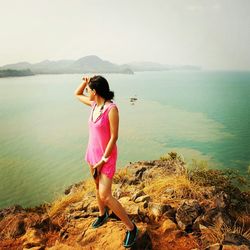 Rear view of woman standing on beach