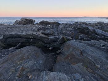 Scenic view of sea against clear sky at sunset