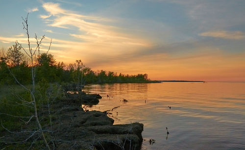 Scenic view of lake against sky during sunset