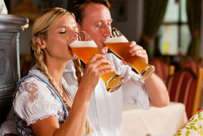 Couple drinking beer at restaurant