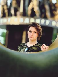Portrait of a young woman sitting outdoors