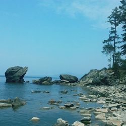 Rocks in sea against sky