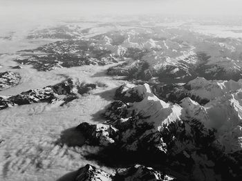 High angle view of sea and mountains against sky