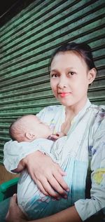 Portrait of mother and daughter outdoors