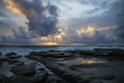 Scenic view of sea against dramatic sky