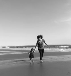 Full length of women on beach against sky