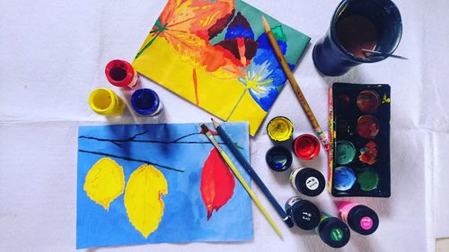 High angle view of various paint on table