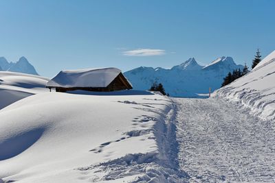 Scenic view of snow covered mountains against sky