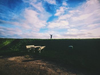 Scenic view of field against cloudy sky