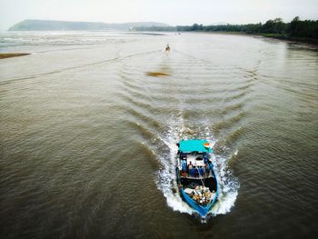 High angle view of people on boat in sea