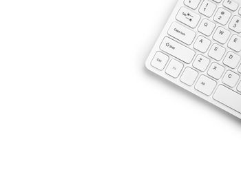 High angle view of computer keyboard over white background