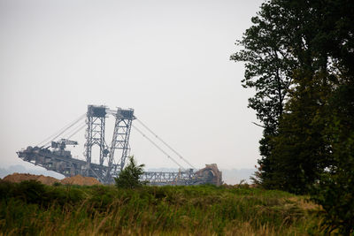 Low angle view of cranes against sky