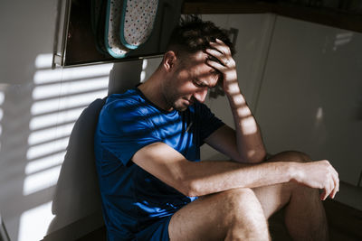 Low angle view of young man using mobile phone