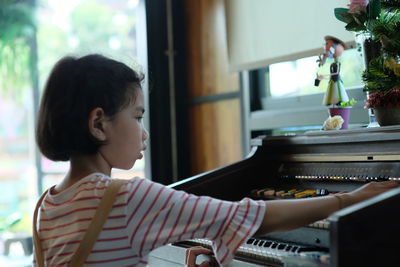 Young woman playing piano