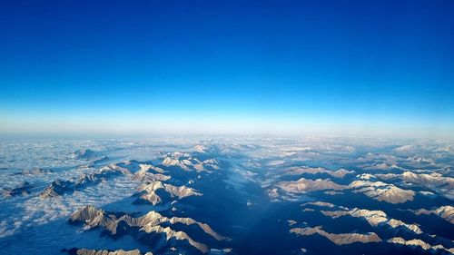 High angle view of dramatic landscape against clear blue sky