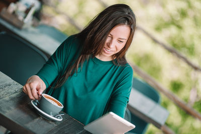 Young woman holding coffee cup