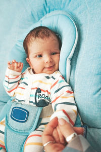 Cute baby girl on bed at home