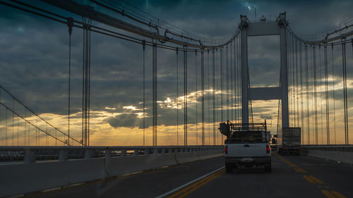 Cars on bridge against sky