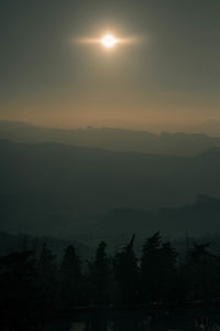 Scenic view of silhouette mountains against sky at sunset