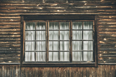 Close-up of closed window in old wooden house