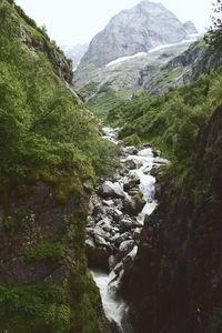 Scenic view of waterfall in mountains