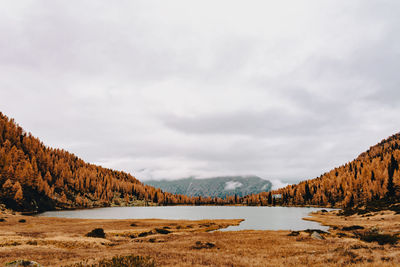 Scenic view of lake and mountains against sky