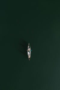 Drone shot of two women in a canoe in the middle of the lake.