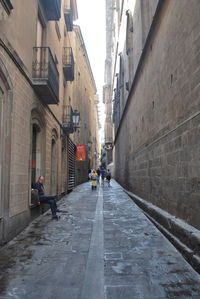 People on road amidst buildings in city