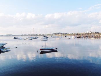 Boats moored on sea against sky