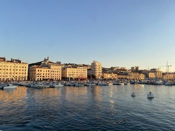 Vieux port of marseille by sunset against clear blue sky