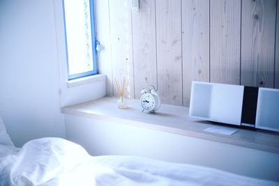 Alarm clock on side table in bedroom