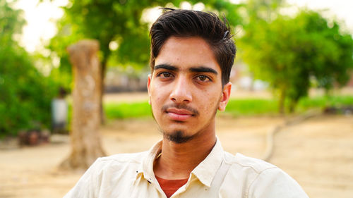 Portrait of young man standing outdoors