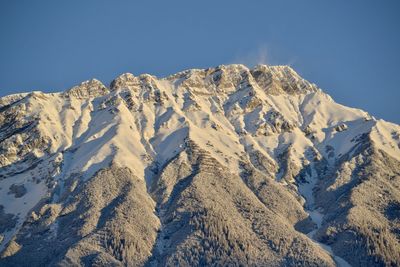 Scenic view of snowcapped mountains against clear sky