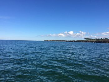 Scenic view of sea against blue sky