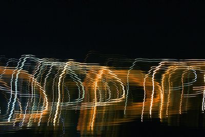 Low angle view of illuminated sky at night