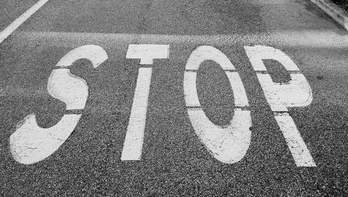 High angle view of text sign on road