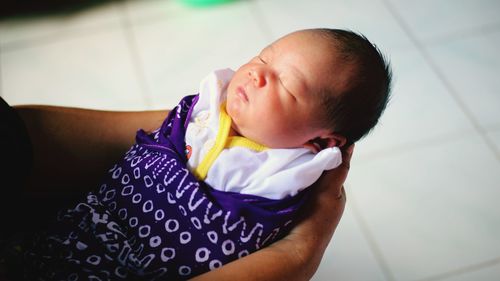 High angle view of cute baby sleeping