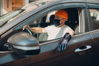 Reflection of woman sitting in car