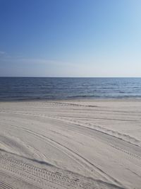 Scenic view of beach against clear blue sky