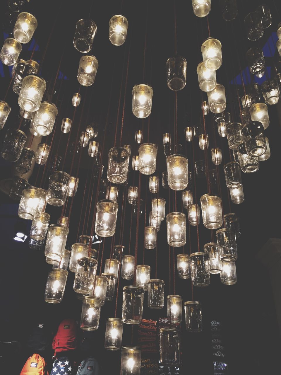 illuminated, indoors, lighting equipment, night, hanging, in a row, large group of objects, electricity, decoration, light - natural phenomenon, abundance, glowing, repetition, arrangement, low angle view, luxury, chandelier, order, lit, electric light