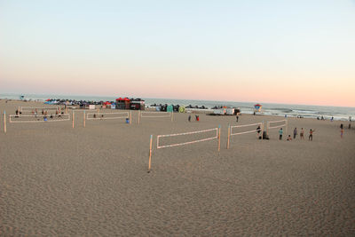 Panoramic view of people on beach against clear sky