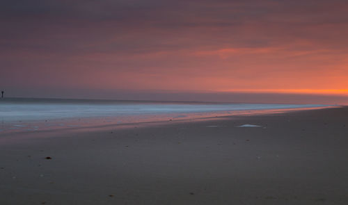 Scenic view of beach against sky during sunset